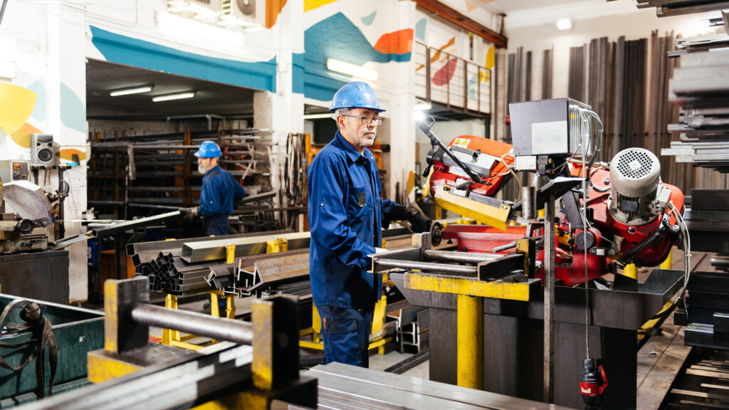 Metals featured image showing workers operating manufacturing process in a metal factory