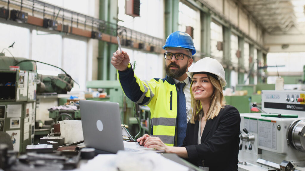 Nissen Chemitec Case Study Featured image showing male and female coworkers discussing automotive manufacturing operations on factory shop floor