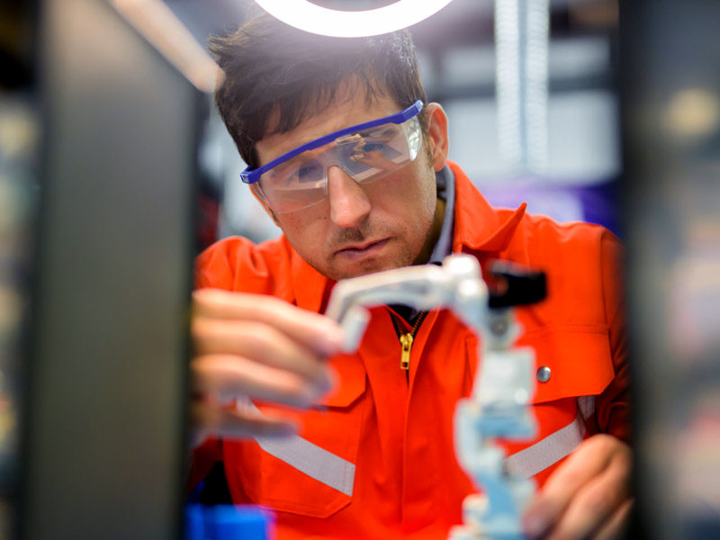 Man using plastic components to assemble high value medical device